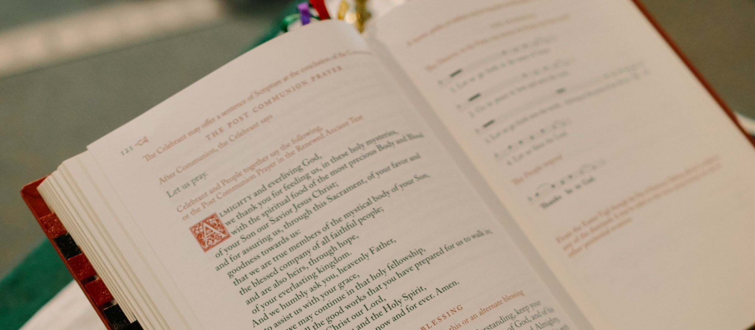 An open prayer book on the lectern at St. Andrew's, showing the Post Communion Prayer from the 2019 Book of Common Prayer.